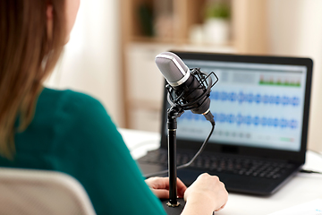 Image showing woman with microphone recording podcast at studio