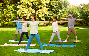 Image showing group of people doing yoga at summer park