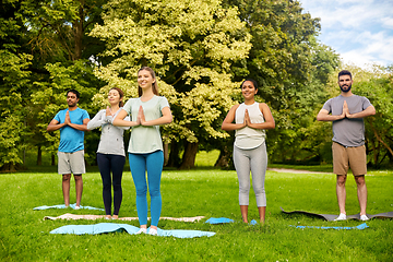 Image showing group of people doing yoga at summer park