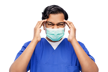 Image showing stressed indian doctor in mask having headache