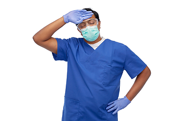 Image showing tired indian male doctor in blue uniform and mask