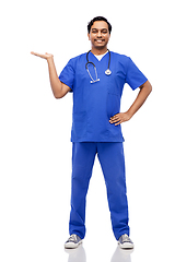 Image showing happy indian male doctor holding something on hand