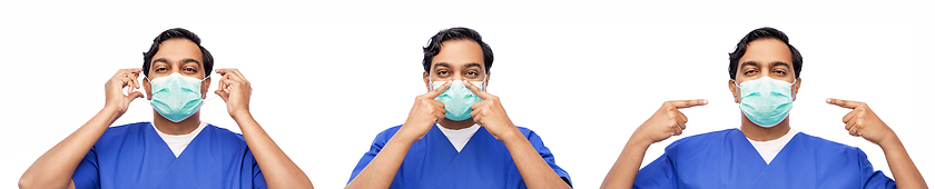 Image showing indian male doctor in blue uniform putting mask on