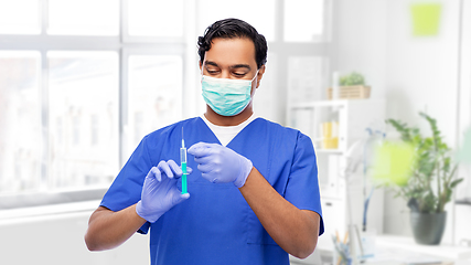 Image showing indian male doctor in mask with vaccine in syringe