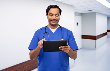 Image showing smiling doctor or male nurse using tablet computer