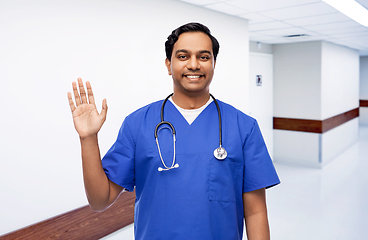 Image showing doctor or male nurse with stethoscope waving hand