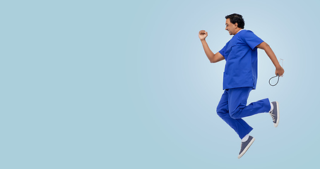 Image showing doctor or male nurse with stethoscope jumping