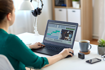 Image showing woman with video editor program on laptop at home