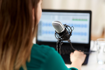 Image showing woman with microphone recording podcast at studio