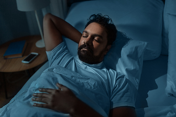 Image showing indian man sleeping in bed at home at night