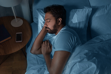 Image showing indian man sleeping in bed at home at night