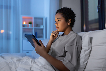 Image showing woman with tablet pc in bed at home at night