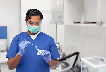 Image showing male doctor in mask with cotton swab and test tube