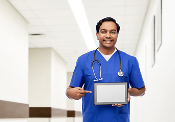 Image showing happy doctor or male nurse showing tablet computer