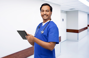 Image showing smiling doctor or male nurse using tablet computer