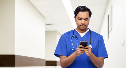 Image showing indian doctor or male nurse using smartphone