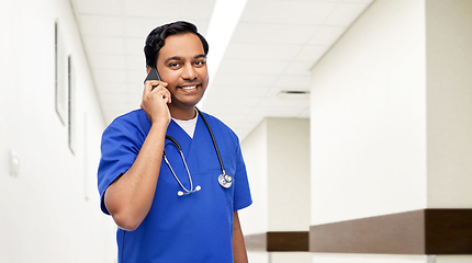 Image showing indian doctor or male nurse calling on smartphone