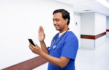 Image showing doctor or male nurse having video call on phone