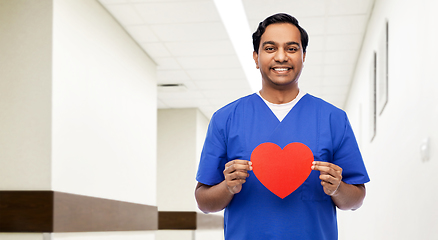 Image showing indian male doctor with red heart on clipboard