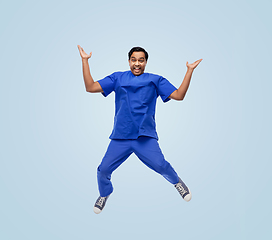 Image showing doctor or male nurse with stethoscope jumping