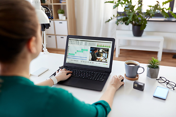 Image showing woman with video editor program on laptop at home