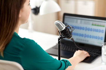 Image showing woman with microphone recording podcast at studio