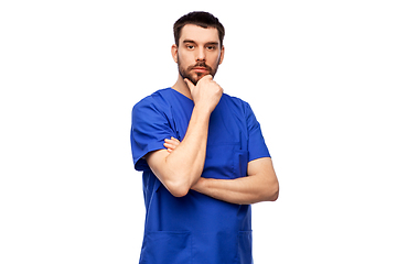 Image showing thinking doctor or male nurse in blue uniform