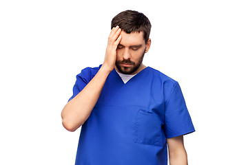 Image showing stressed doctor or male nurse in blue uniform