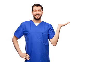 Image showing smiling male doctor holding something on hand