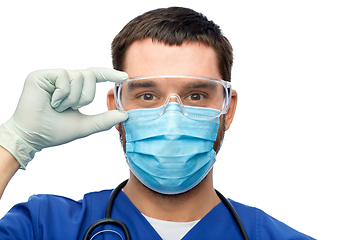 Image showing male doctor in goggles, mask and gloves