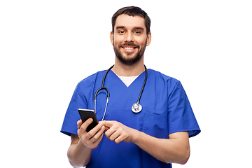 Image showing smiling doctor or male nurse using smartphone