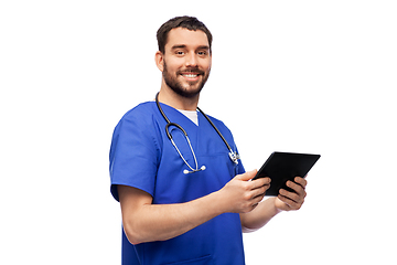 Image showing smiling doctor or male nurse using tablet computer