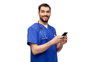 Image showing smiling doctor or male nurse using smartphone