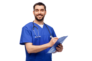 Image showing male doctor writing medical report on clipboard