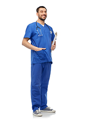 Image showing smiling doctor in blue uniform with clipboard