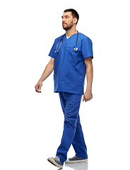 Image showing doctor or male nurse with stethoscope walking