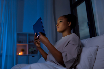 Image showing woman with tablet pc in bed at home at night