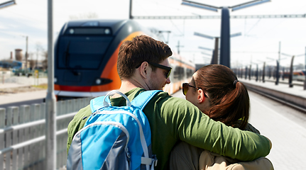 Image showing happy couple with backpacks traveling by train