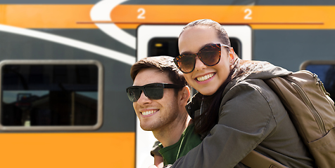 Image showing happy couple with backpacks traveling by train