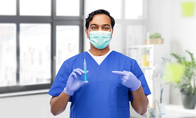 Image showing indian male doctor in mask with vaccine in syringe