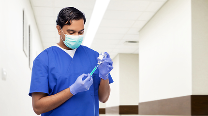 Image showing indian doctor in mask with syringe and medicine