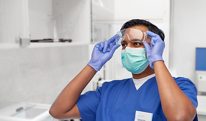 Image showing indian male doctor in blue uniform and mask