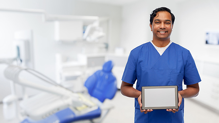 Image showing doctor or male dentist showing tablet computer