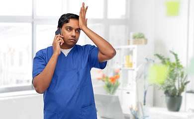 Image showing indian doctor or male nurse calling on smartphone