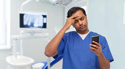 Image showing indian doctor or male nurse using smartphone