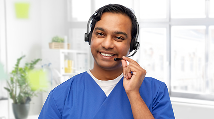 Image showing smiling indian doctor or male nurse with headset