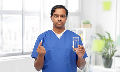 Image showing indian doctor with medicine and glass of water