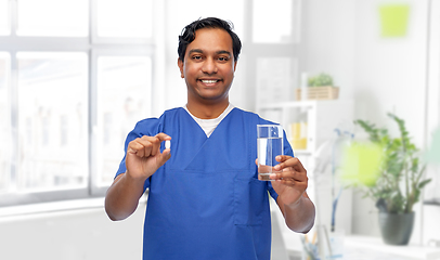 Image showing indian doctor with medicine and glass of water