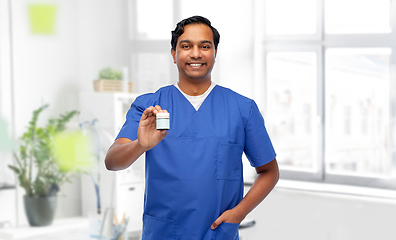 Image showing indian doctor or male nurse holding medicine