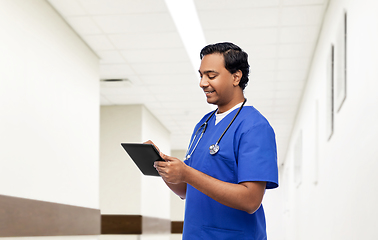 Image showing indian doctor or male nurse using tablet computer